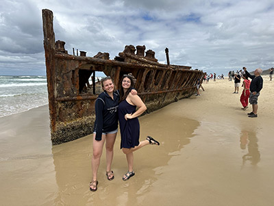Lauren and a friend at a shipwreck on K'gari Island