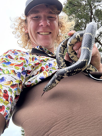 Lucas Wilson holding an eastern king snake