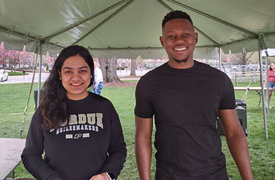 Bindu Paudel and Jean Fritz Saint Preux pictured at Purdue's Farm to Fork Day where they collected surveys about maple syrup on campus