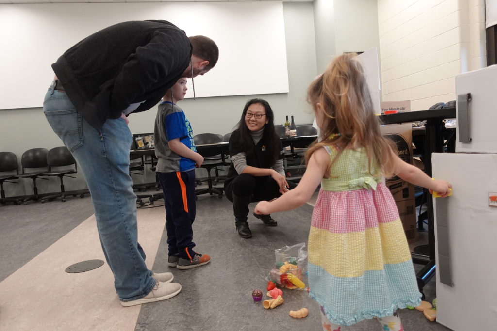 Dr. Feng working with the kids at Spring Fest