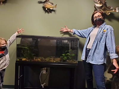McCallen stands by an aquarium with her son in 2022.