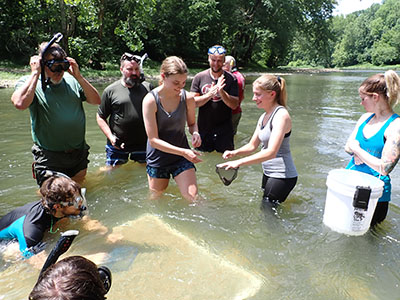 Summer Brown at a hellbender release in the Blue River