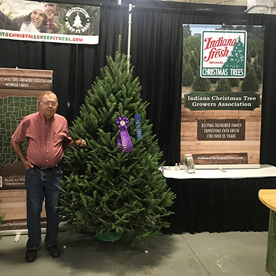 Dan Cassens with 2021 Grand Champion tree at the Indiana State Fair