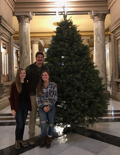 Cassidy Robinson with Ed and Amy Oehlman delivering a Cassens tree to the state capitol.