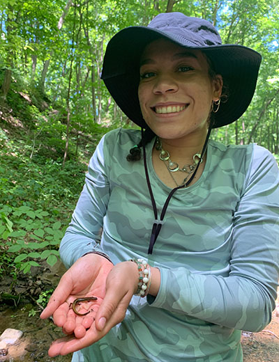 Sophia Flores holds a salamander in her hands