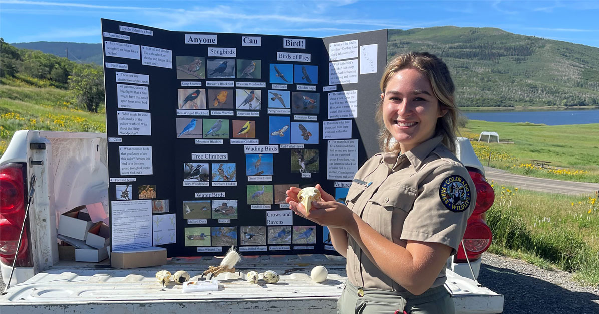 Sophomore wildlife major Emma Johnson holding a bald eagle skull, presenting her Anyone Can Bird program for the first time at Vega State Park.