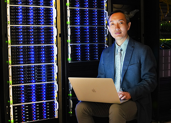 Dr. Jing Jing Liang with computer servers.