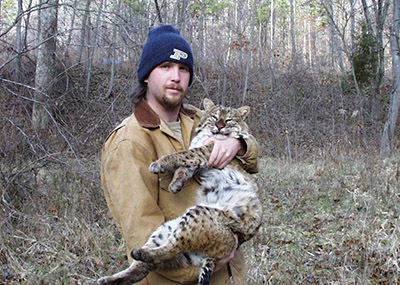 Trent Osmon holds a bobcat