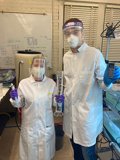 Meredith Scherer in the lab with a colleague