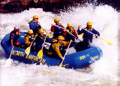 Harvey Holt whitewater rafting with students during fall break 1997