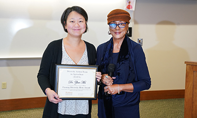 Dr. Zhao Ma is presented the Unsung Diversity Hero Award from Dr. Pam Morris