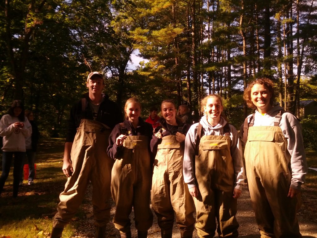 Students and advisor in waders.