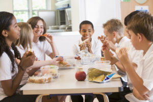 children eating lunch in a school cafeteria