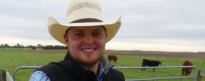 Jared Forgey in pasture overlooking cattle