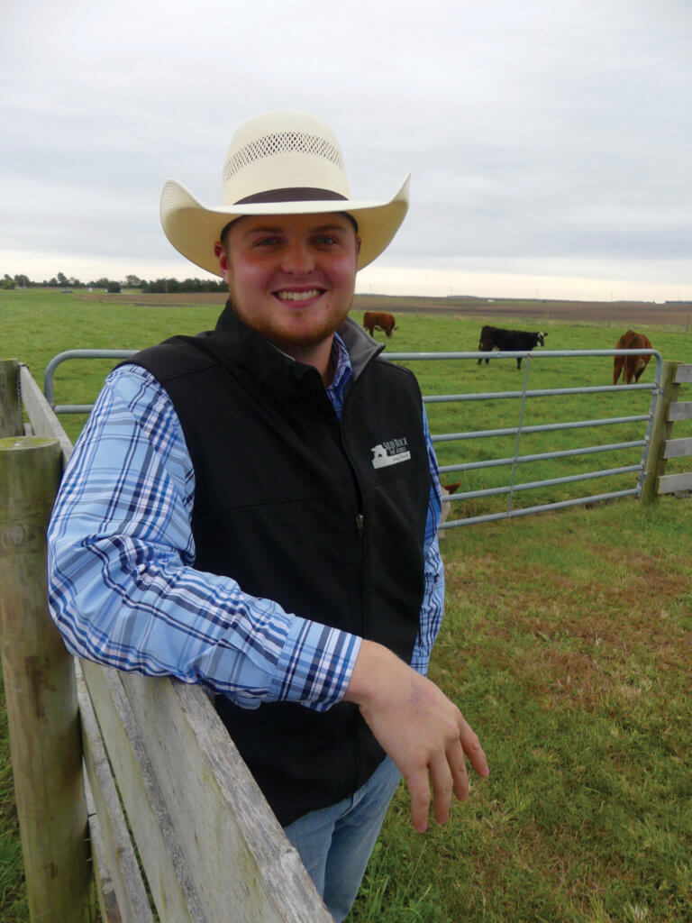 Jared Forgey standing in cattle field.