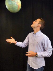Dane Chapman tossing globe into the air