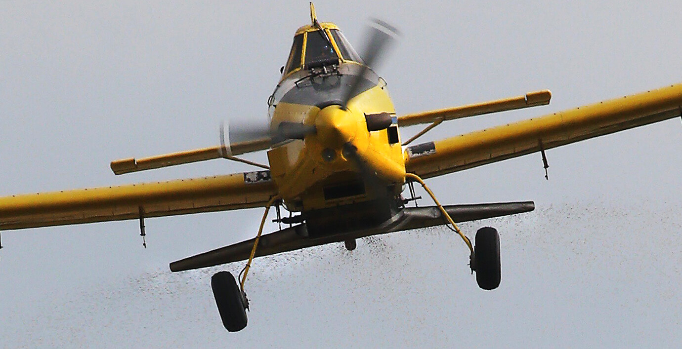 The yellow plane, zoomed in on as it flies