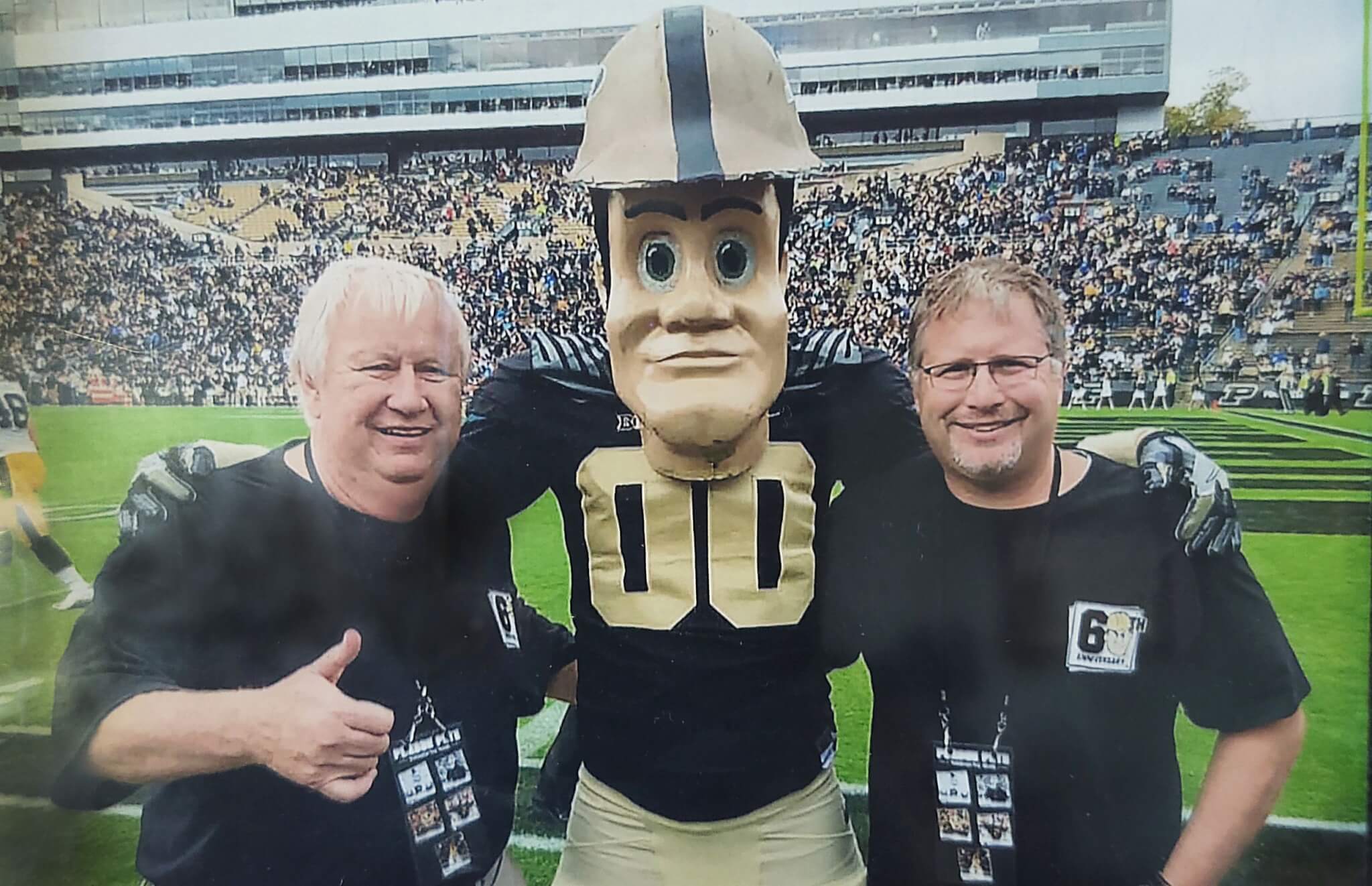 Father and son Purdue Pete in front of field