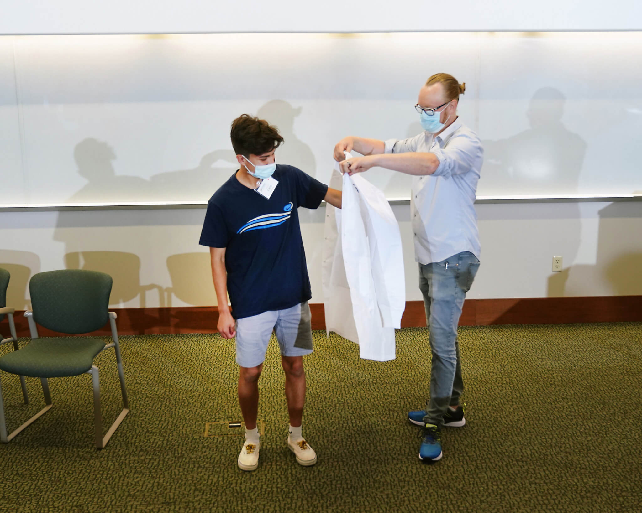 Students received white lab coats at the begining of the week. Photo by Tom Campbell.