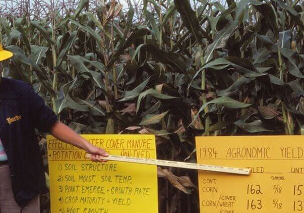 Eileen Kladivko performed a 35-year research project at SEPAC on field tile drainage. Pointing at signs.